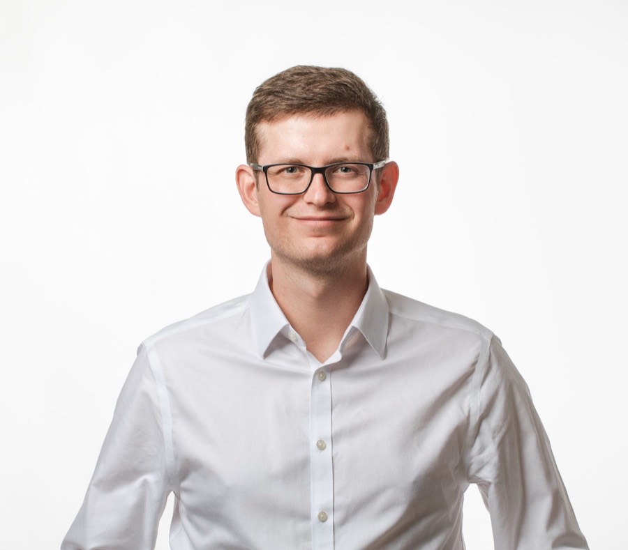 Petr Špecián, photographed in a white shirt against a plain background